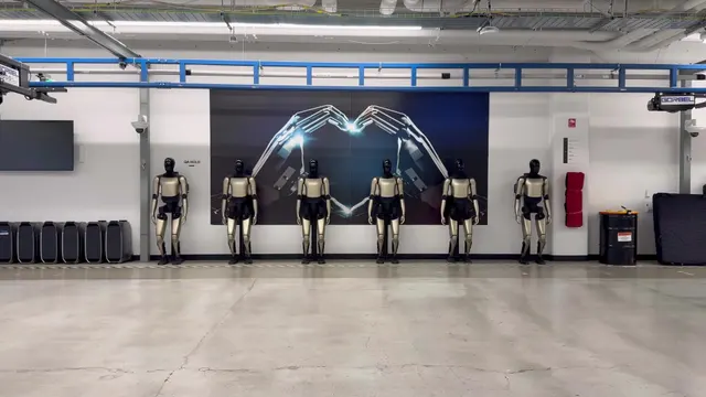 A row of Optimus units in a Tesla lab