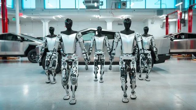 Several Optimus units walking in a Tesla lab